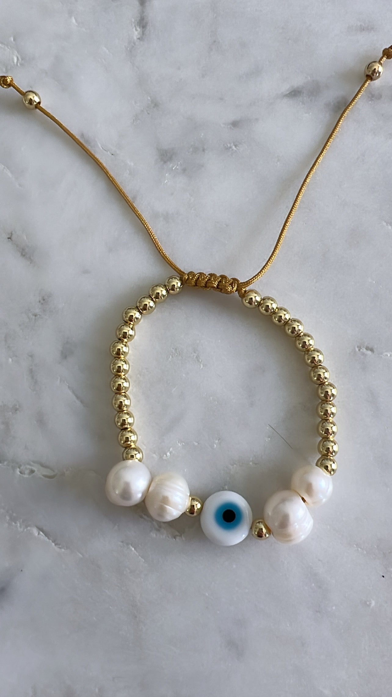 Pearl/evil eye bracelet